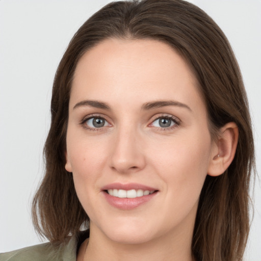 Joyful white young-adult female with long  brown hair and grey eyes