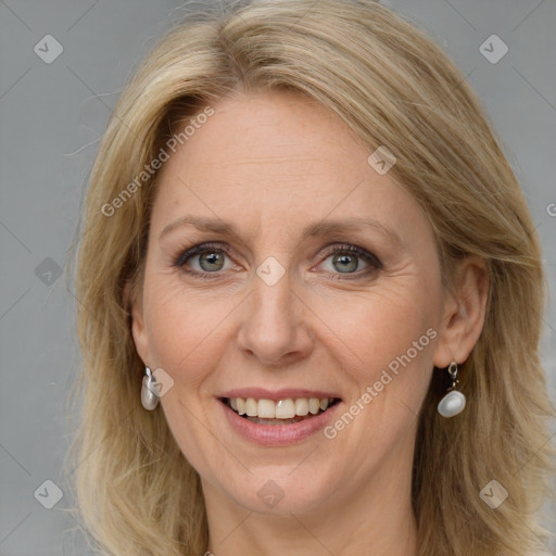 Joyful white adult female with long  brown hair and blue eyes