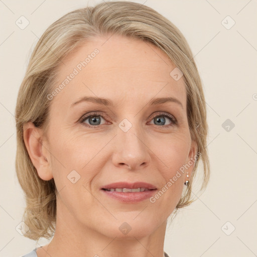 Joyful white adult female with medium  brown hair and blue eyes