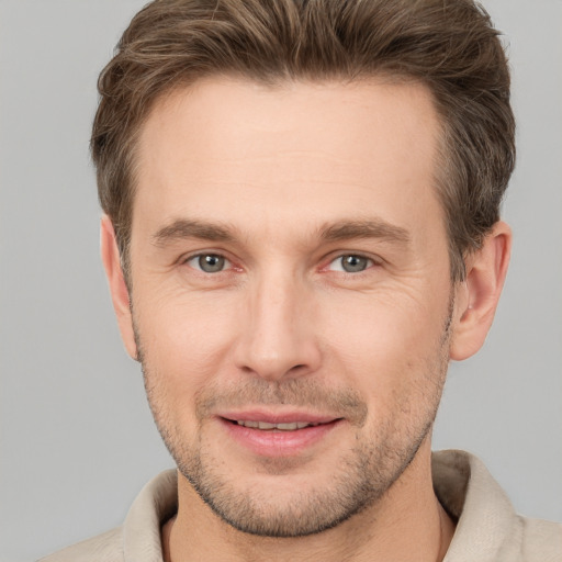 Joyful white adult male with short  brown hair and brown eyes