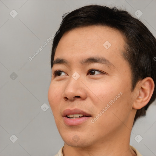 Joyful asian young-adult male with short  brown hair and brown eyes