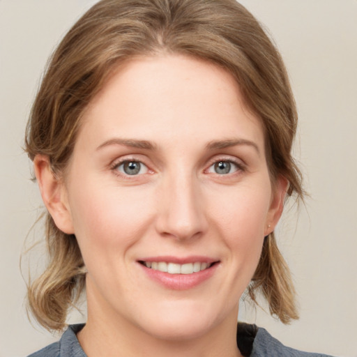 Joyful white young-adult female with medium  brown hair and blue eyes