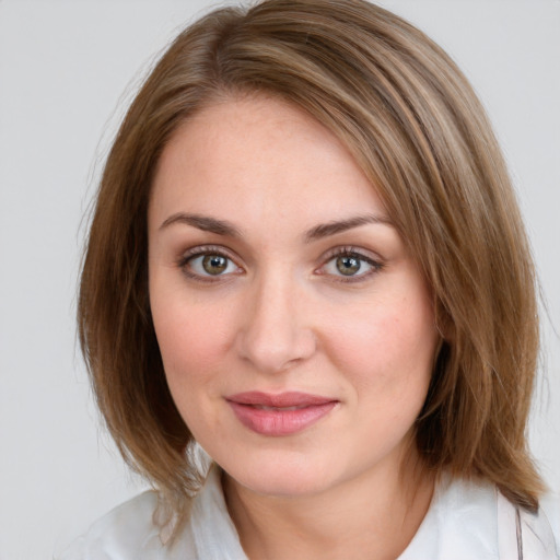 Joyful white young-adult female with medium  brown hair and green eyes