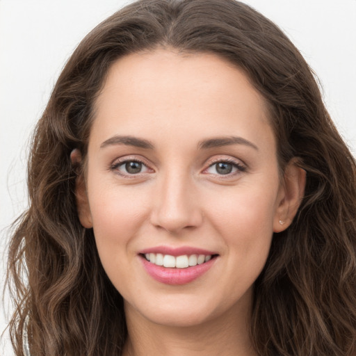 Joyful white young-adult female with long  brown hair and grey eyes