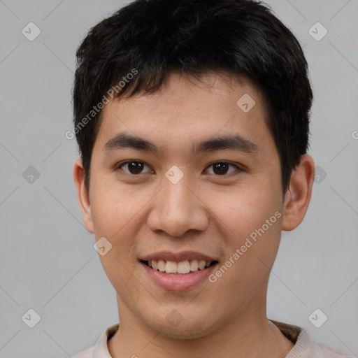 Joyful asian young-adult male with short  brown hair and brown eyes