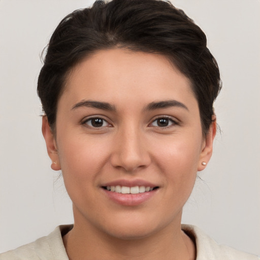 Joyful white young-adult female with short  brown hair and brown eyes