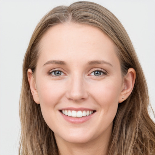 Joyful white young-adult female with long  brown hair and grey eyes