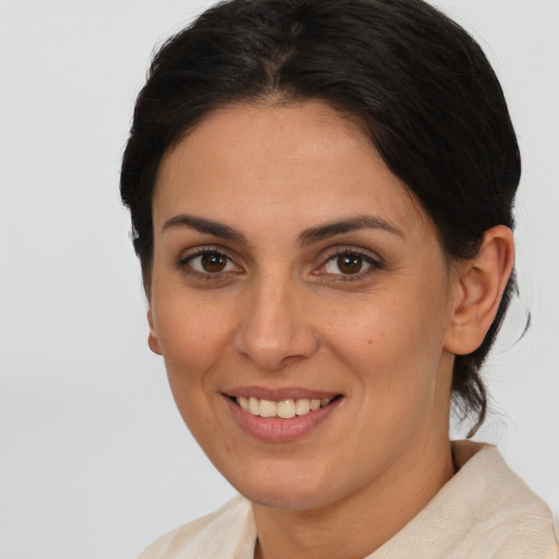 Joyful white adult female with medium  brown hair and brown eyes
