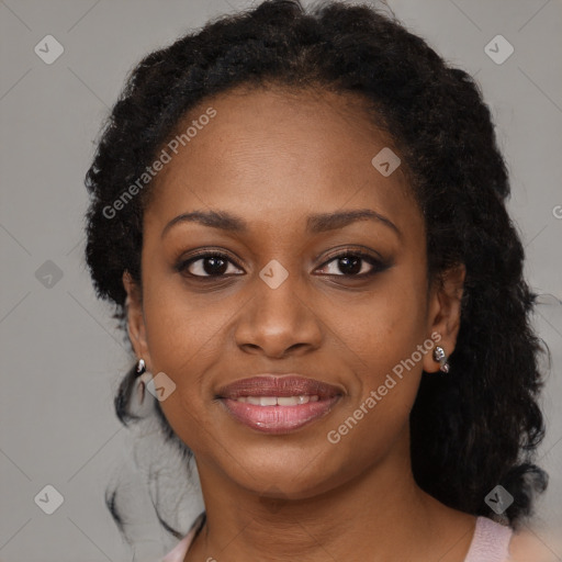 Joyful black young-adult female with long  black hair and brown eyes