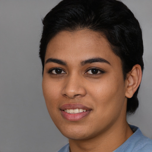Joyful latino young-adult female with short  black hair and brown eyes