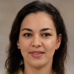 Joyful latino young-adult female with medium  brown hair and brown eyes