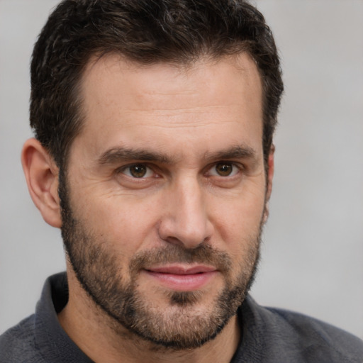 Joyful white adult male with short  brown hair and brown eyes