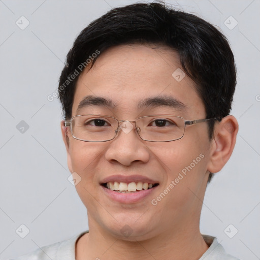 Joyful asian young-adult male with short  brown hair and brown eyes