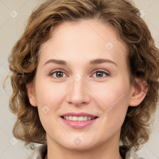 Joyful white young-adult female with medium  brown hair and green eyes