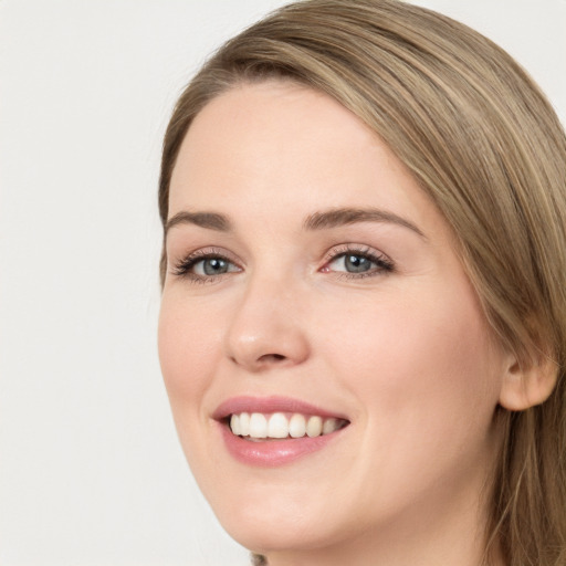 Joyful white young-adult female with long  brown hair and green eyes