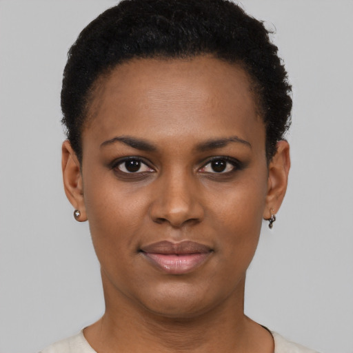 Joyful black young-adult female with short  brown hair and brown eyes