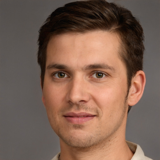 Joyful white young-adult male with short  brown hair and brown eyes