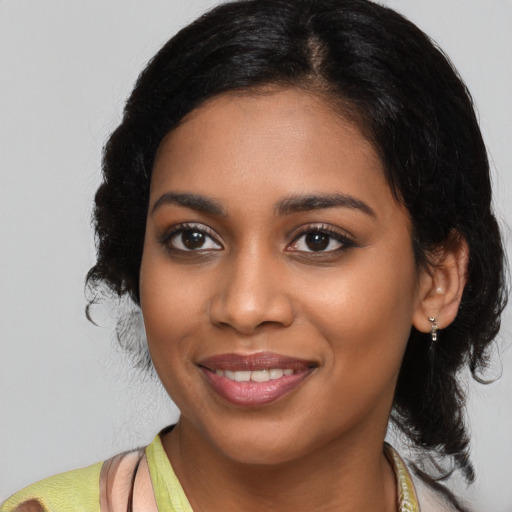 Joyful black young-adult female with medium  black hair and brown eyes