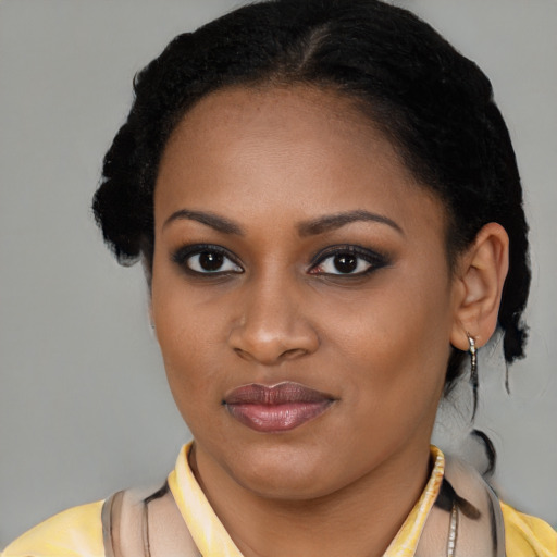 Joyful black young-adult female with short  brown hair and brown eyes