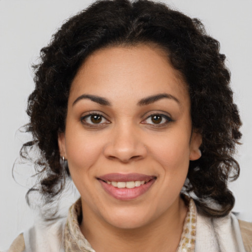 Joyful black young-adult female with medium  brown hair and brown eyes