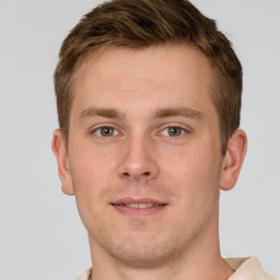 Joyful white young-adult male with short  brown hair and grey eyes