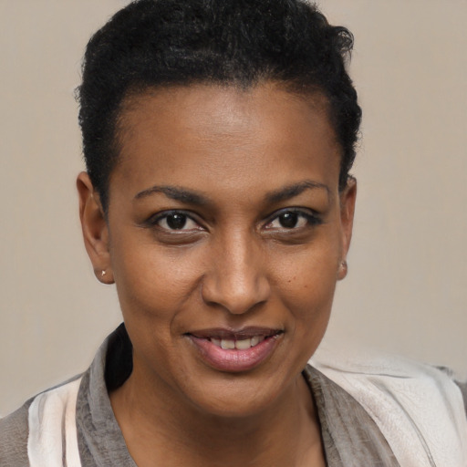 Joyful black young-adult female with short  brown hair and brown eyes