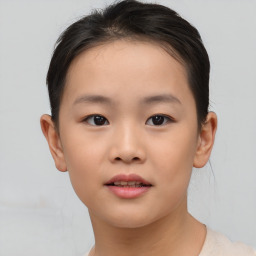 Joyful asian child female with short  brown hair and brown eyes