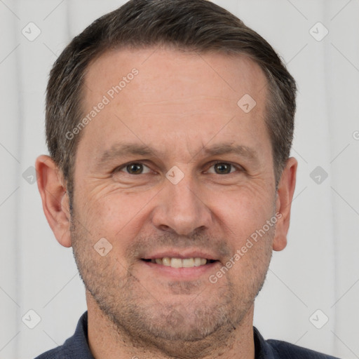 Joyful white adult male with short  brown hair and brown eyes