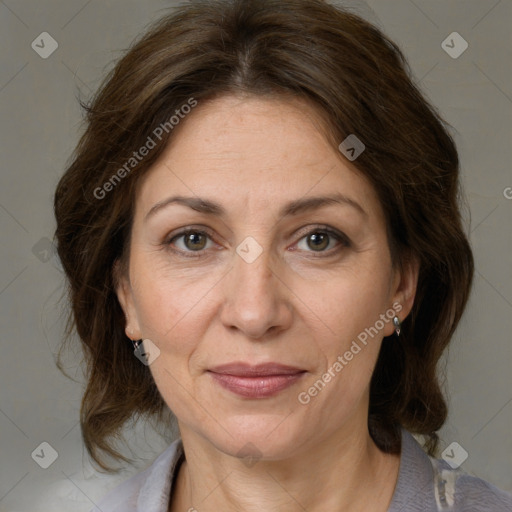 Joyful white adult female with medium  brown hair and grey eyes