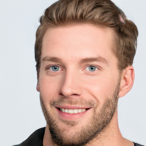 Joyful white young-adult male with short  brown hair and blue eyes