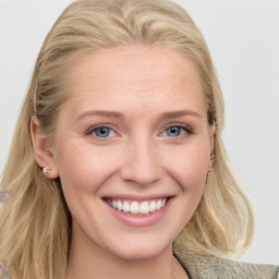 Joyful white young-adult female with long  brown hair and blue eyes