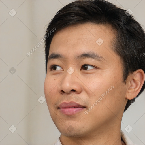 Joyful asian young-adult male with short  brown hair and brown eyes