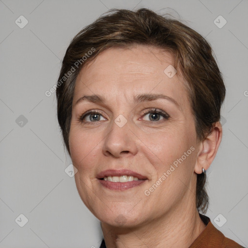 Joyful white adult female with medium  brown hair and grey eyes