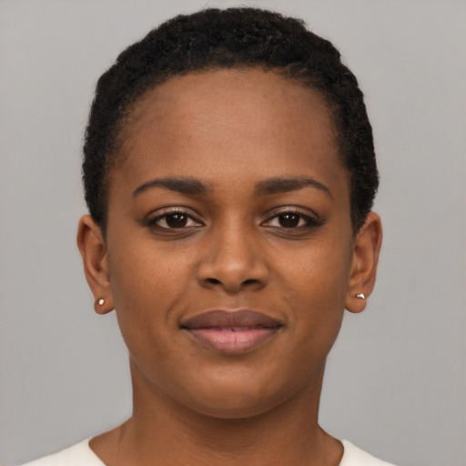 Joyful black young-adult female with short  brown hair and brown eyes