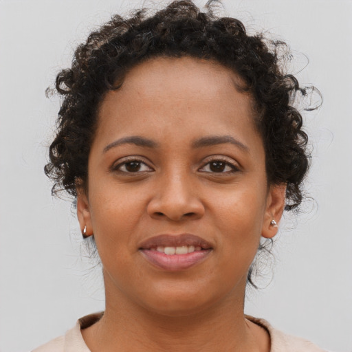 Joyful black young-adult female with short  brown hair and brown eyes