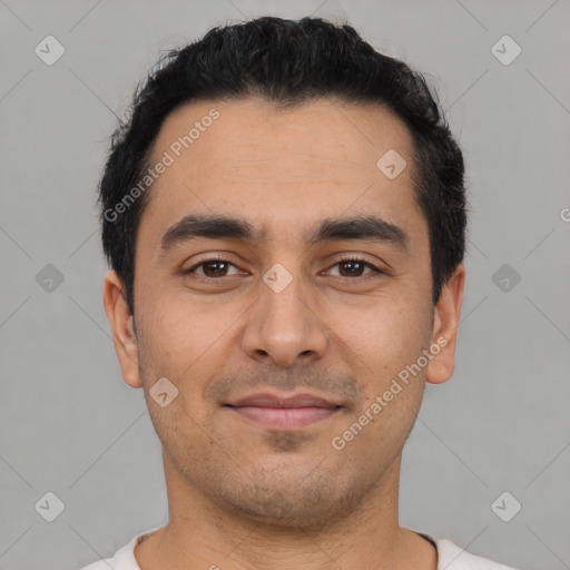 Joyful latino young-adult male with short  black hair and brown eyes