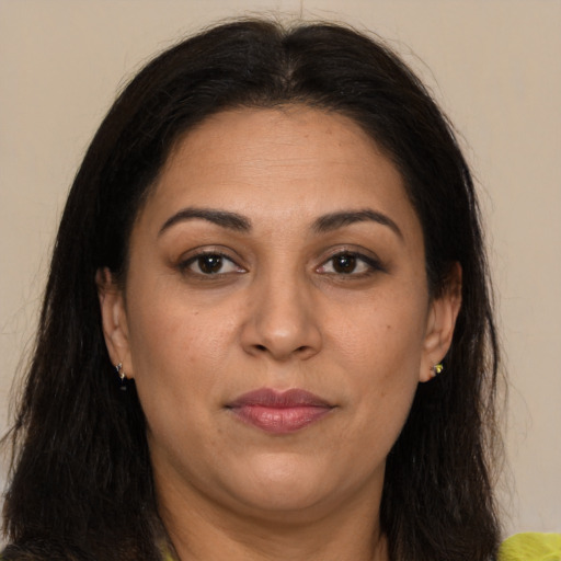 Joyful latino adult female with long  brown hair and brown eyes