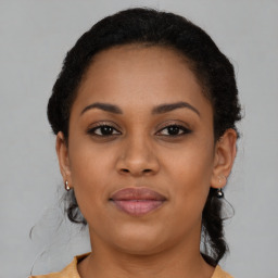 Joyful black young-adult female with short  brown hair and brown eyes