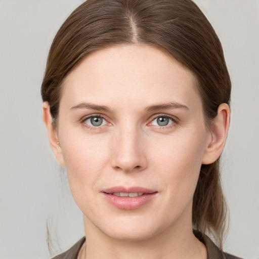 Joyful white young-adult female with medium  brown hair and grey eyes