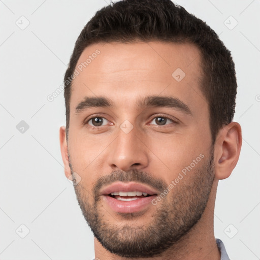 Joyful white young-adult male with short  brown hair and brown eyes