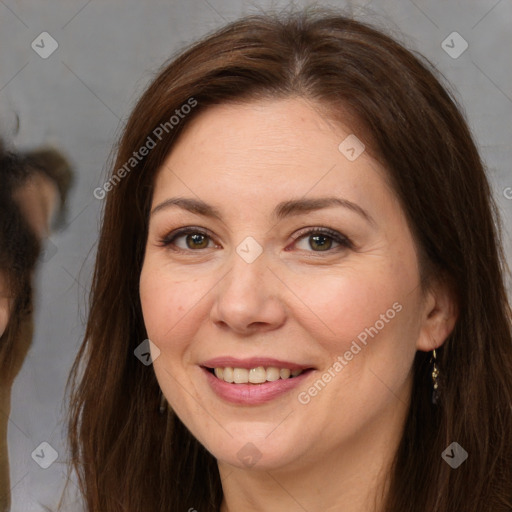 Joyful white adult female with long  brown hair and brown eyes