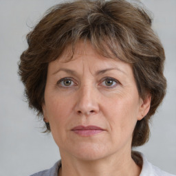 Joyful white middle-aged female with medium  brown hair and brown eyes