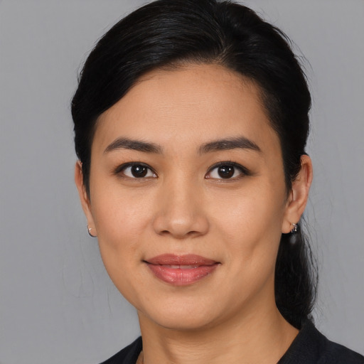 Joyful latino young-adult female with medium  black hair and brown eyes