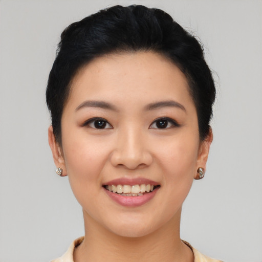 Joyful asian young-adult female with short  black hair and brown eyes