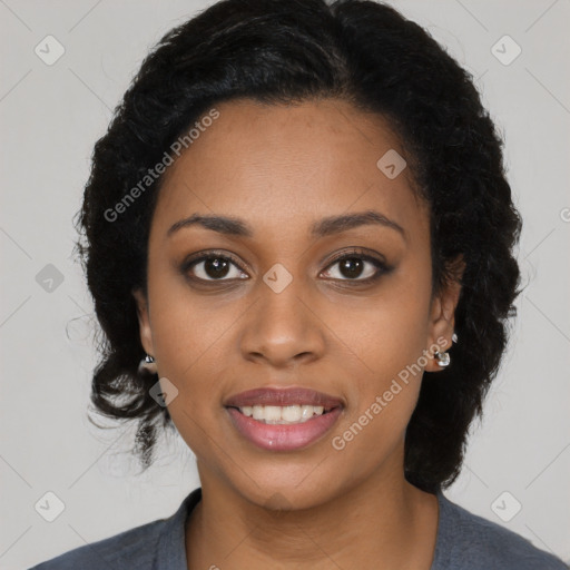 Joyful black young-adult female with long  black hair and brown eyes