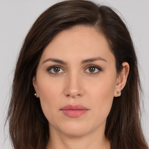 Joyful white young-adult female with long  brown hair and brown eyes