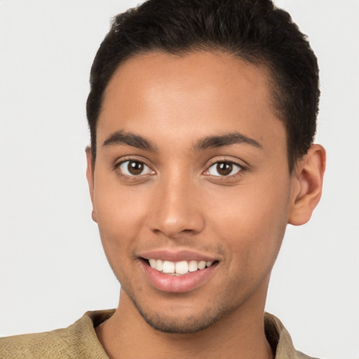 Joyful latino young-adult male with short  brown hair and brown eyes