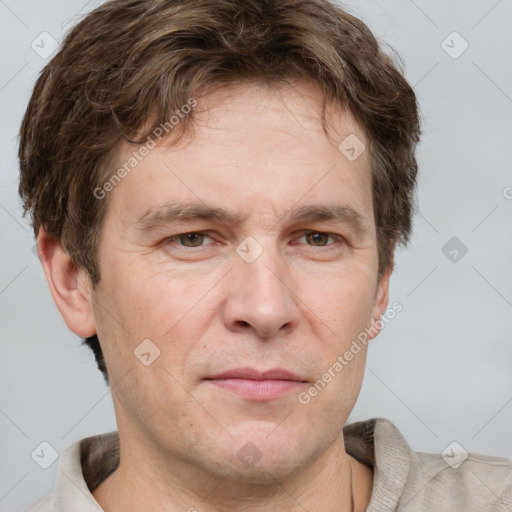 Joyful white adult male with short  brown hair and grey eyes