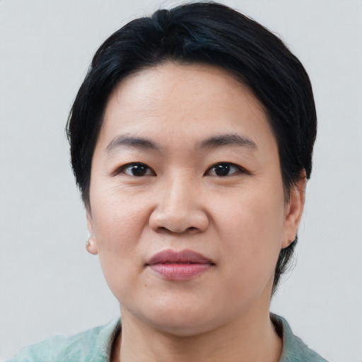 Joyful asian young-adult female with medium  black hair and brown eyes