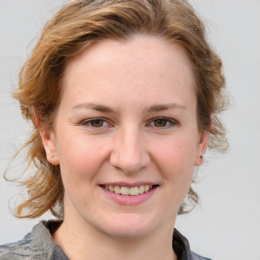 Joyful white young-adult female with medium  brown hair and blue eyes